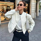 Women's modern bomber jacket made of durable fabric, featuring front pockets and a sleek, fitted design for everyday wear.