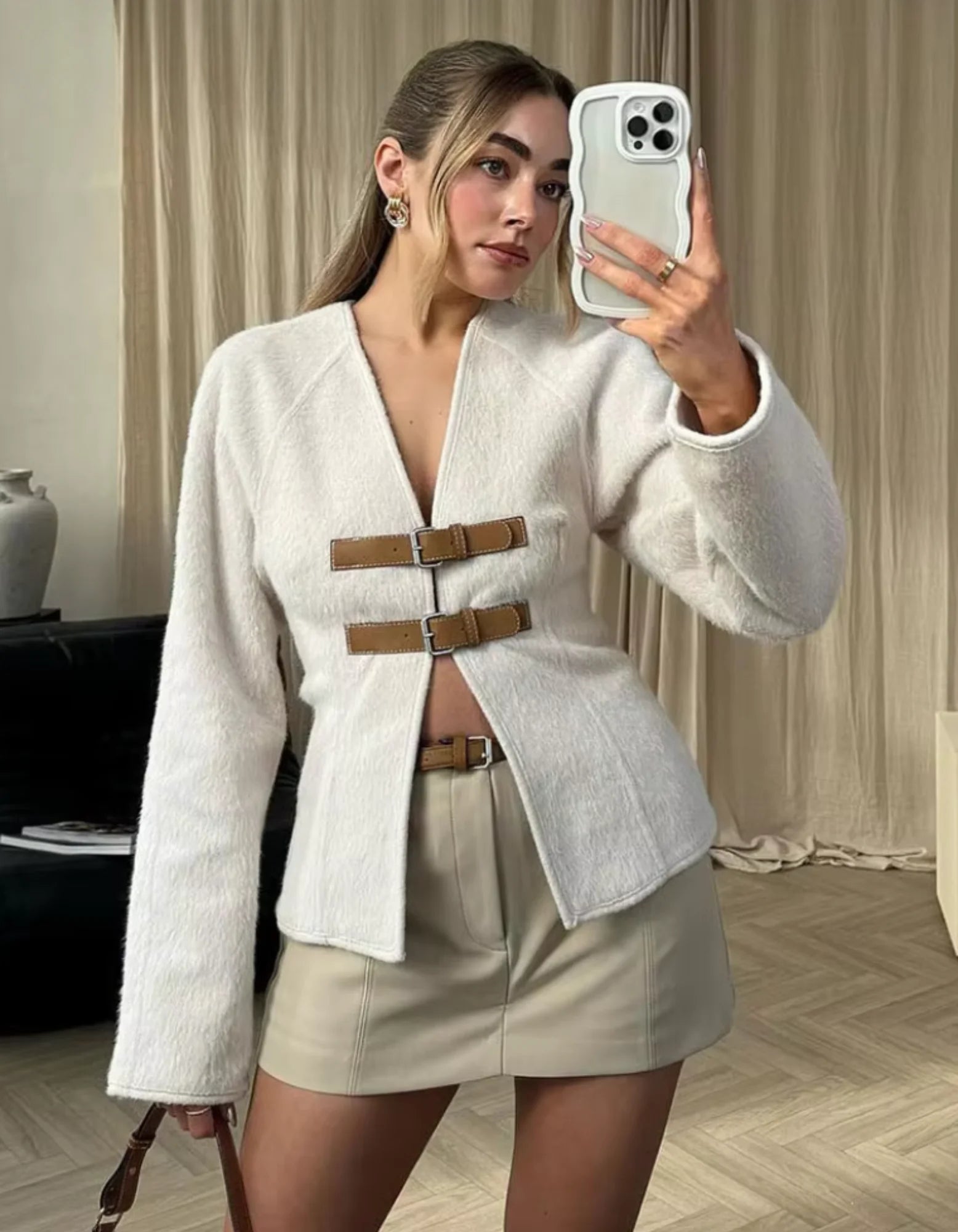 Women's modern strap cardigan featuring beige accents, made from soft knit fabric with an open-front design.