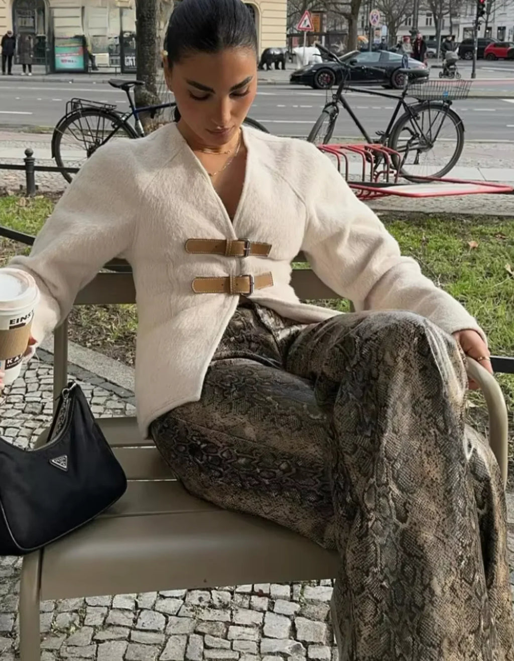 Women's modern strap cardigan featuring beige accents, crafted from soft fabric with an open front and relaxed fit.