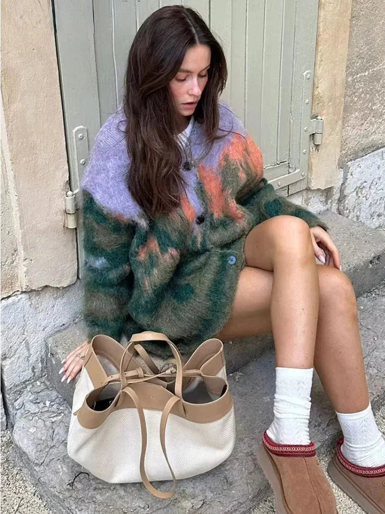 Women's multicolor fuzzy cardigan featuring long sleeves, soft knitted material, and a cozy, oversized fit.