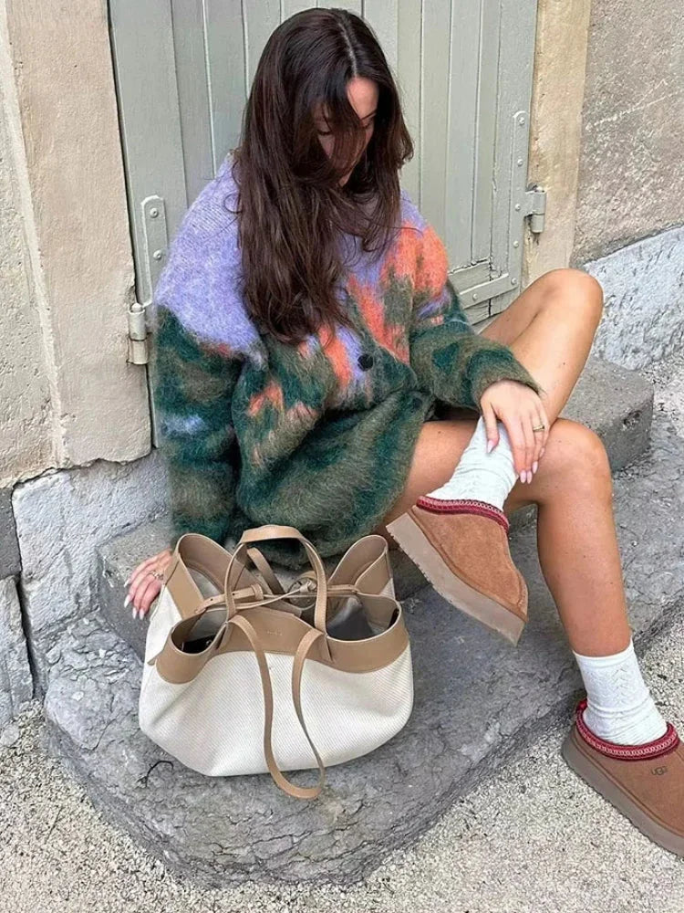 Women's multicolor fuzzy cardigan with long sleeves, made from soft yarn, featuring a relaxed fit and cozy knit texture.