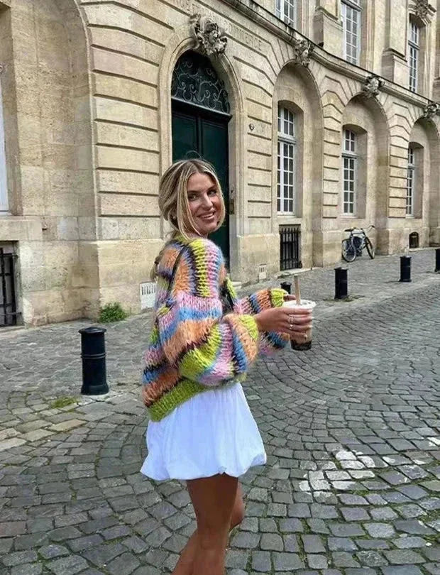 Multicolor knitted women's cardigan featuring a playful pattern, crafted from soft, breathable yarn for comfort and style.