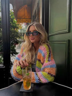 Women's multicolor knitted cardigan featuring a playful pattern and soft fiber, perfect for layering in cooler weather.