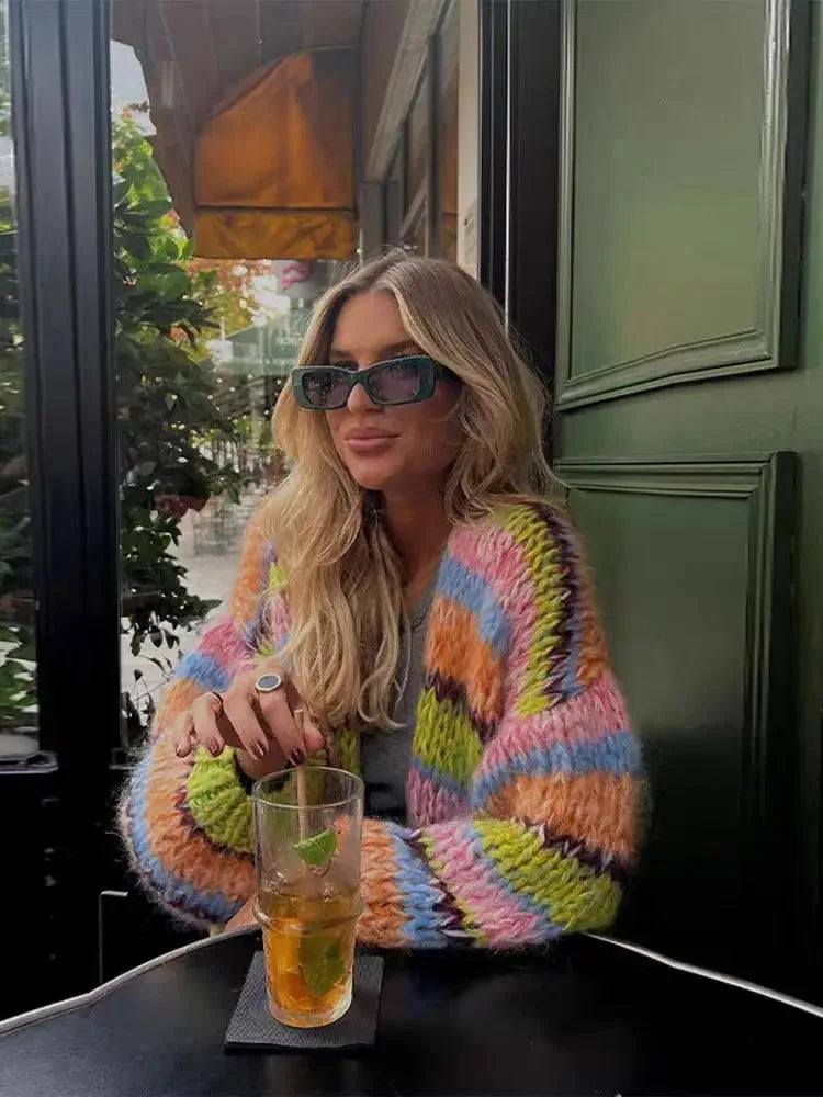 Women's multicolor knitted cardigan featuring a playful pattern and soft fiber, perfect for layering in cooler weather.