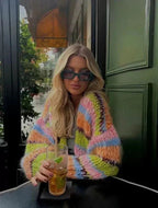 Women's multicolor knitted cardigan featuring a playful pattern, made of soft yarn for comfort and warmth during cooler days.