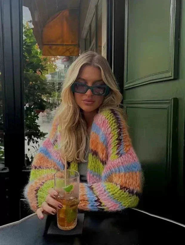 Women's multicolor knitted cardigan featuring a playful pattern, made of soft yarn for comfort and warmth during cooler days.