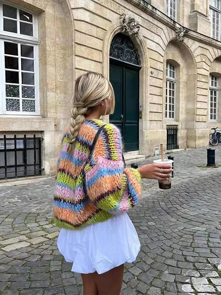 Women's multicolor knitted cardigan featuring a playful pattern, crafted from soft, cozy yarn for comfort and warmth.