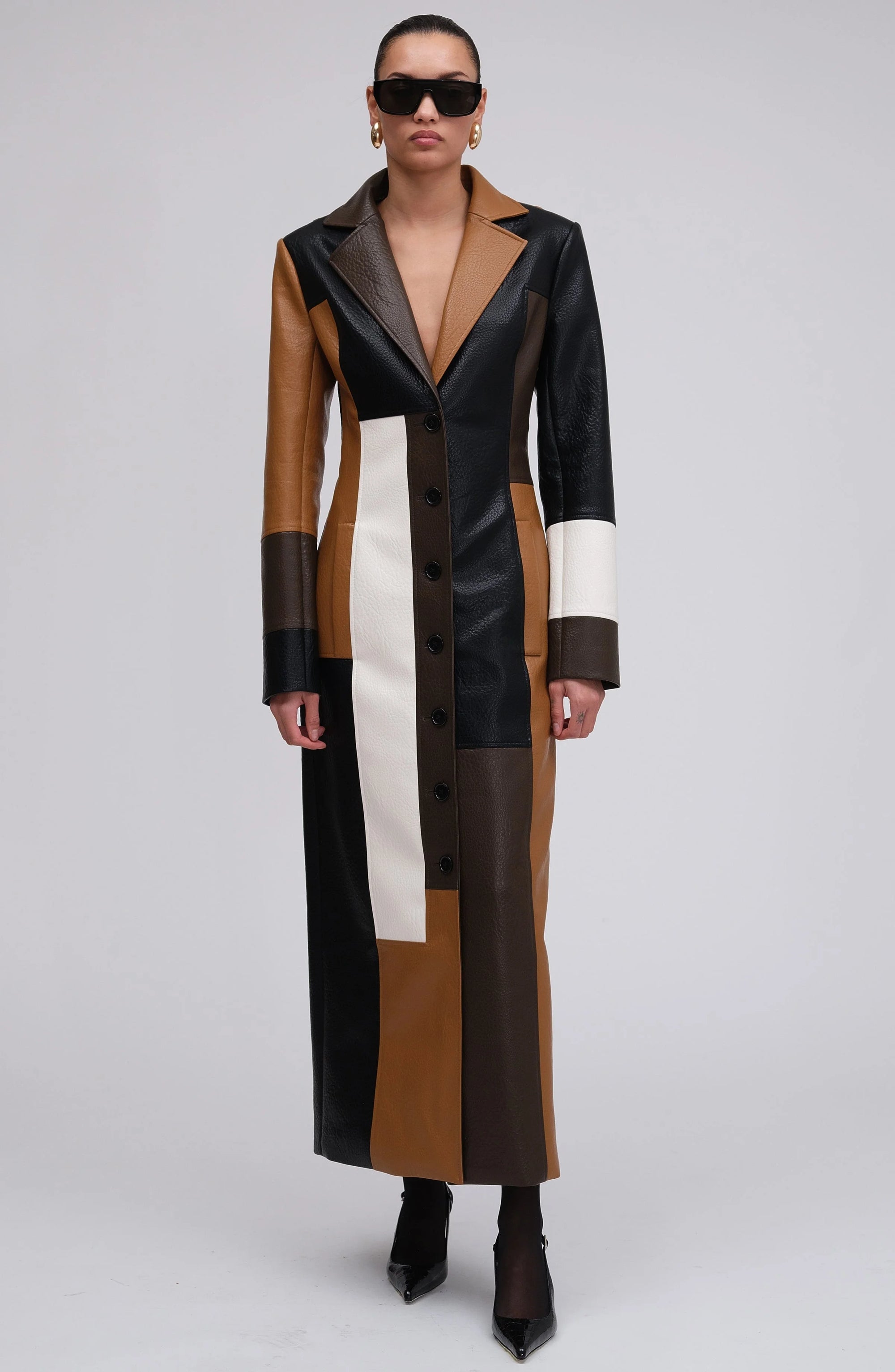 Women's multicolor patchwork long coat featuring button closures and a blend of fabrics for a unique, textured design.