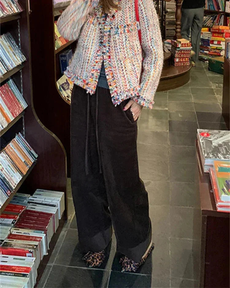 Women's multicolor tweed jacket featuring fringed edges and a textured fabric, perfect for layering in cool weather.