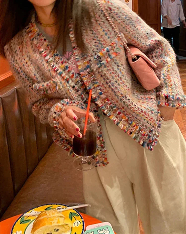 Women's multicolor tweed jacket featuring fringed edges and a textured fabric, perfect for adding style to any outfit.
