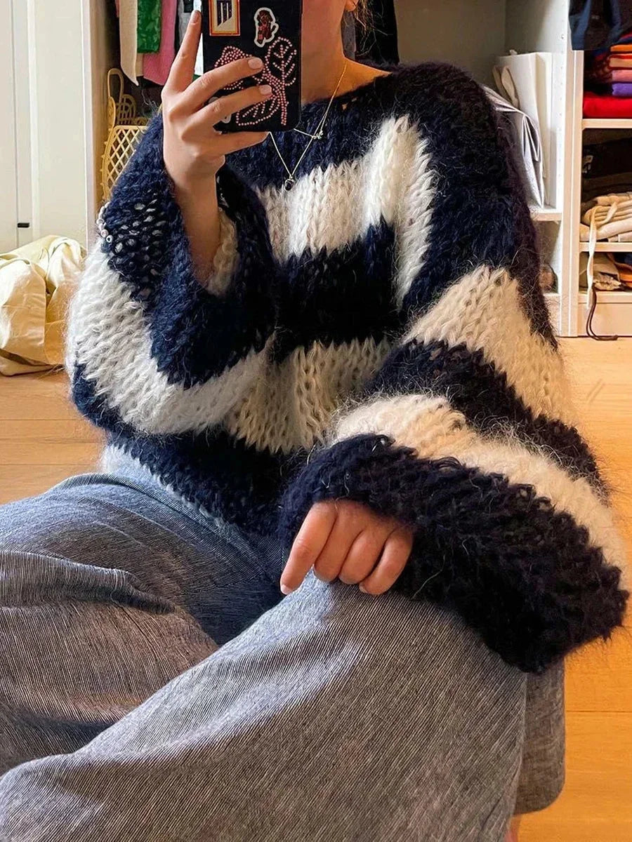 Women's navy and white chunky striped sweater made from soft knit fabric, featuring a relaxed fit and ribbed neckline.