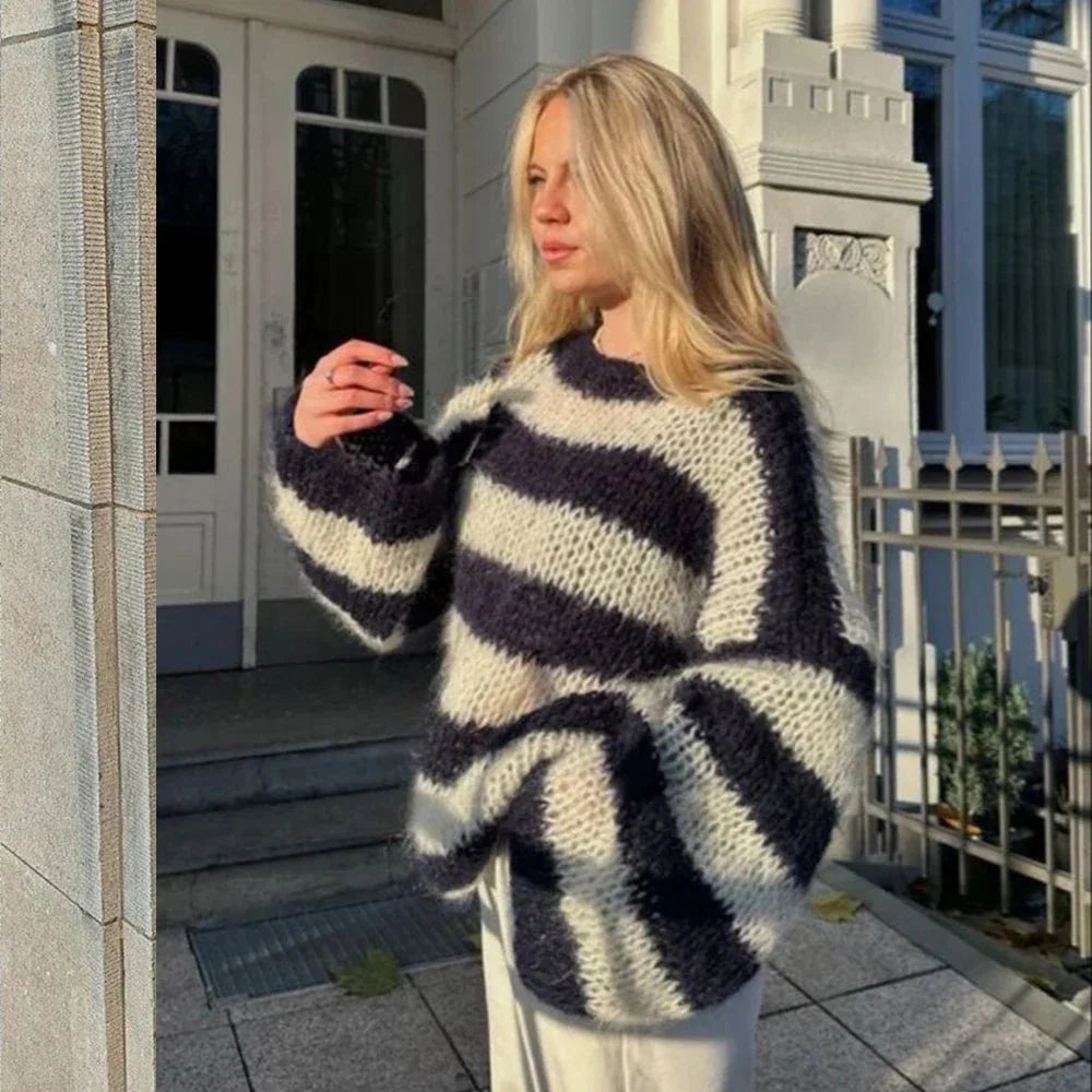 Alt text: Women's navy and white chunky striped sweater made of soft knit fabric, featuring a relaxed fit and long sleeves.