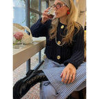 Women's navy cardigan with buttons, relaxed fit, made from soft cotton blend for comfort and easy styling.