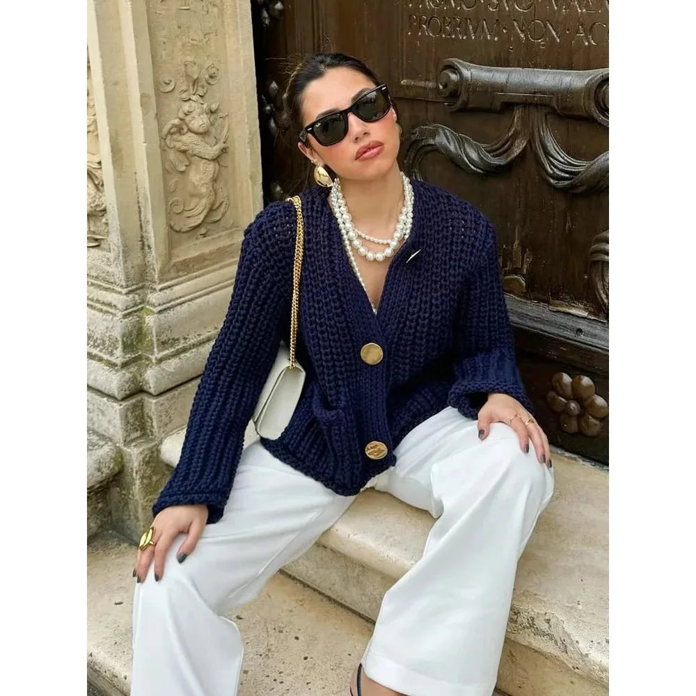 Women's navy buttoned cardigan featuring a relaxed fit, soft fabric, and classic design for versatile layering.