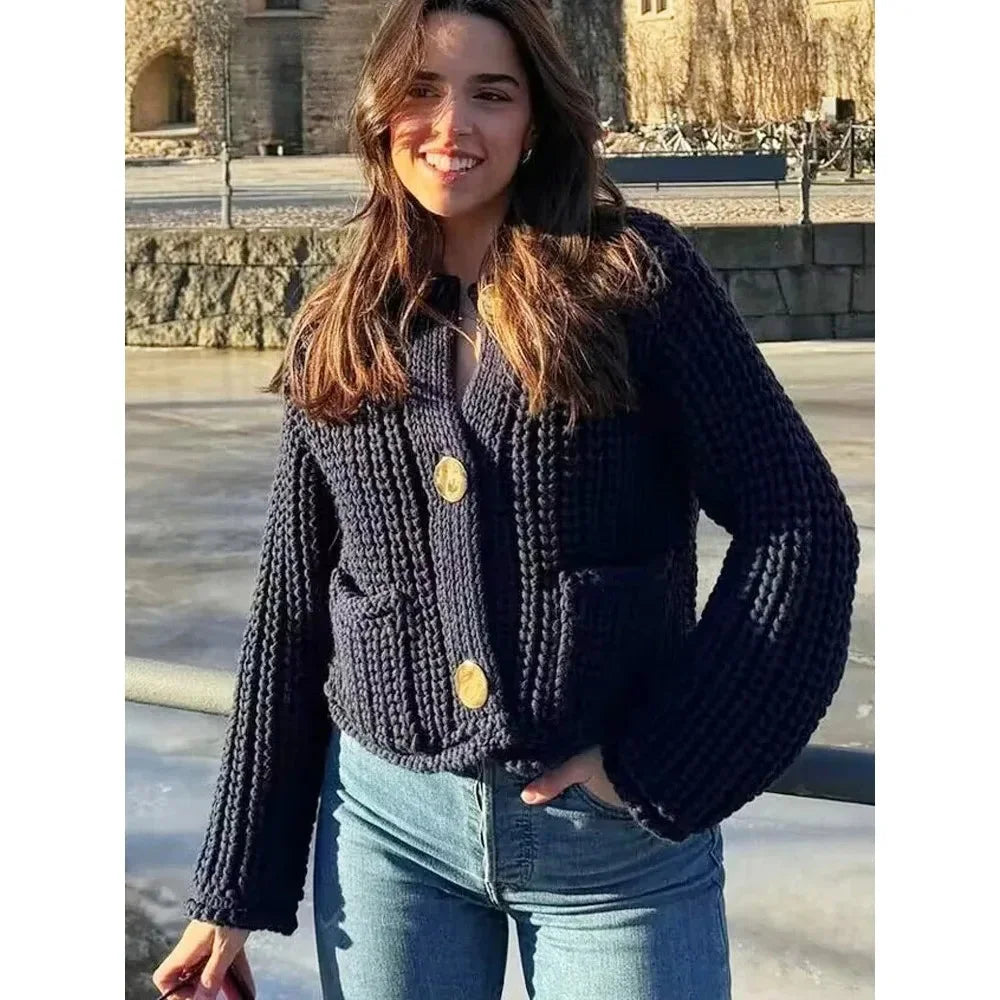 Women's navy buttoned cardigan in a relaxed fit made from soft cotton blend, featuring a classic design and ribbed cuffs.