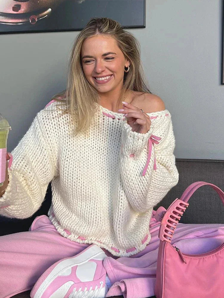 Women’s off-shoulder knitted sweater in soft fabric, featuring stylish ties for an adjustable, trendy look.