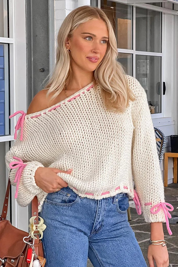 Women's off-shoulder knitted sweater featuring stylish ties, made from soft fabric for a comfortable fit and casual look.