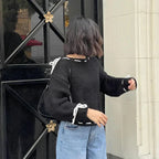 Women's off-shoulder knitted sweater featuring stylish ties and soft material for comfortable wear. Perfect for casual…
