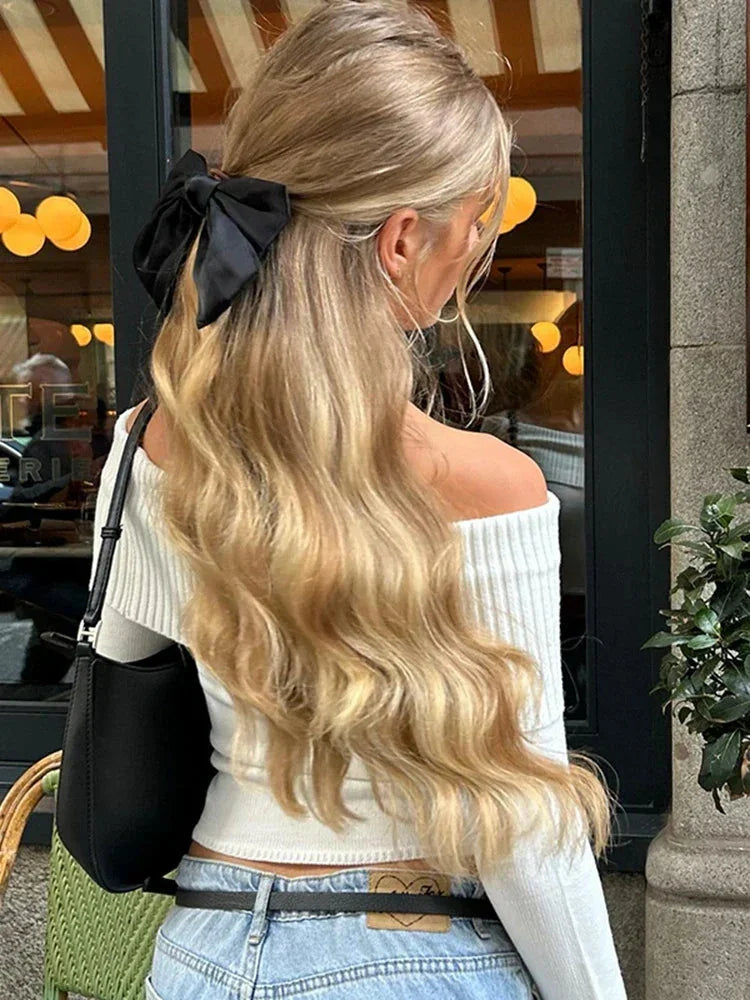 White off-shoulder sweater for women featuring a ribbed neckline and soft knit fabric, perfect for casual layering.