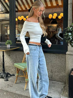 White off-shoulder sweater for women, featuring a ribbed neckline and soft knit fabric, perfect for casual wear.