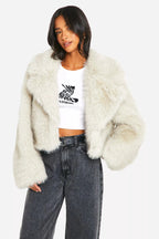 Women's off-white faux fur coat featuring an oversized collar, soft texture, and stylish design for warmth and comfort.