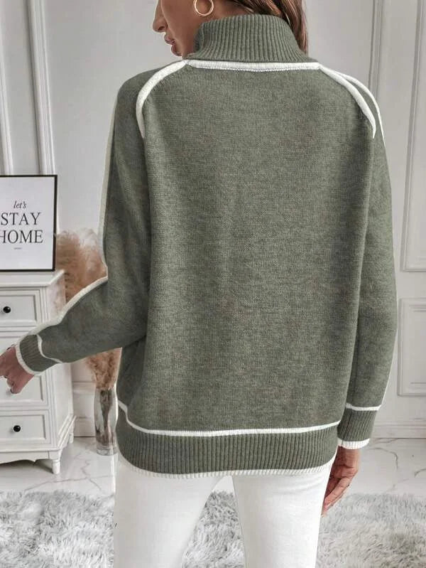 Women's olive turtleneck sweater crafted from soft cotton, featuring contrasting white accents on the cuffs and hem.