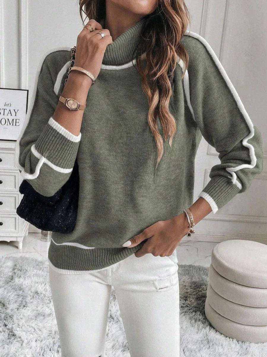 Women's olive turtleneck sweater made of soft cotton, featuring stylish white accents along the cuffs and hem for added…