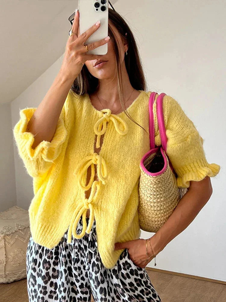 Women's yellow open-front cardigan featuring bow ties, made of soft knit fabric for comfort and a stylish layering option.