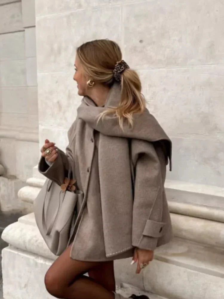Women's oversized beige coat with large buttons, featuring soft fabric and a relaxed fit for casual wear.