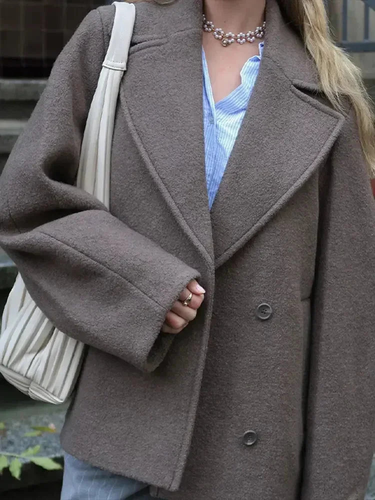 Women's oversized brown jacket made of soft cotton, featuring a button closure and relaxed fit for everyday wear.