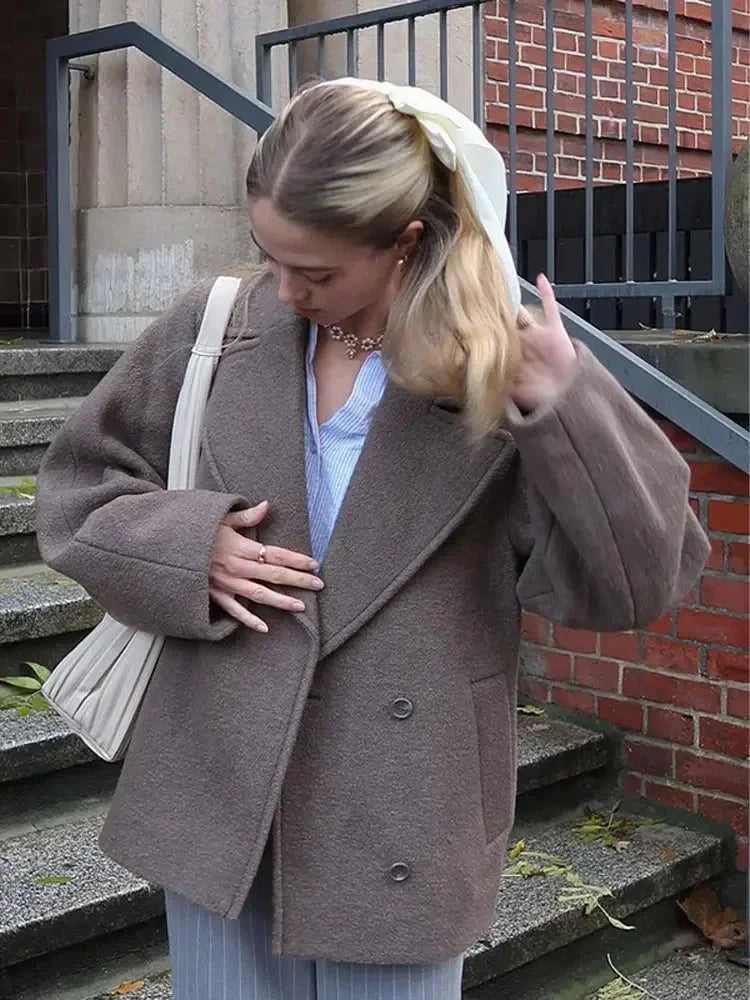 Women's oversized brown jacket featuring button closure, crafted from soft fabric with a relaxed fit for comfort and style.