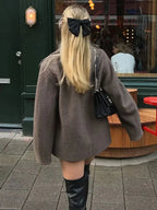 Women's oversized brown jacket featuring button closure, made from soft fabric for comfort and a relaxed fit. Ideal for…