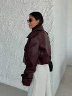 Women's oversized burgundy jacket featuring wide lapels, made from soft fabric for a relaxed fit and stylish layering.