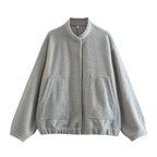 Women's oversized casual bomber jacket with button-front, made from soft cotton blend and featuring ribbed cuffs and hem.
