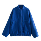 Women's oversized bomber jacket in lightweight fabric, featuring a button-front closure and casual fit for everyday wear.