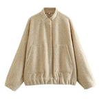 Women's oversized bomber jacket in soft cotton blend, featuring a button-front closure and relaxed fit for casual wear.