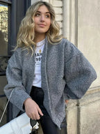 Women's oversized casual bomber jacket featuring a button-front design, made from soft, durable fabric with ribbed cuffs.