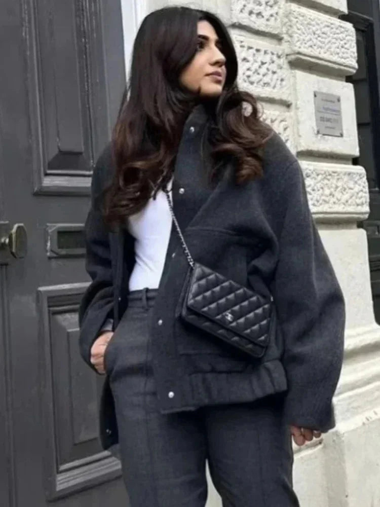 Women’s oversized bomber jacket with button front, made from lightweight fabric, featuring a relaxed fit and side pockets.