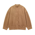 Women's oversized bomber jacket in soft fabric, featuring a button-front design and relaxed fit for casual style.