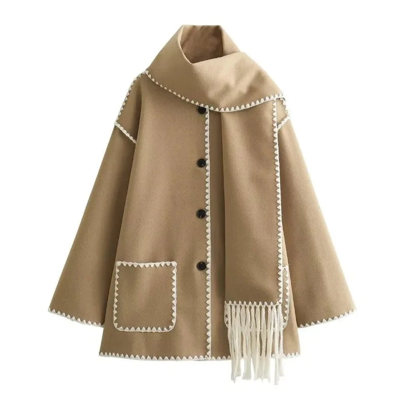 Women's oversized coat with integrated scarf and fringe, made from soft wool blend, featuring a relaxed fit and unique…