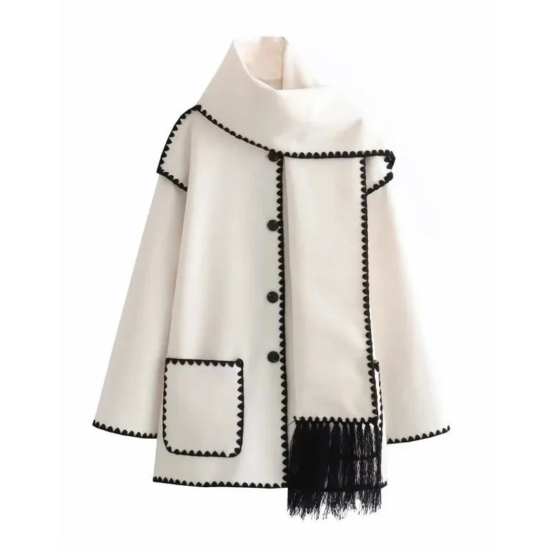 Women's oversized coat in soft wool blend featuring an integrated scarf and playful fringe detail for added warmth.