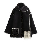 Women’s oversized coat in soft fabric, featuring an integrated scarf and stylish fringe, perfect for layering in cool…