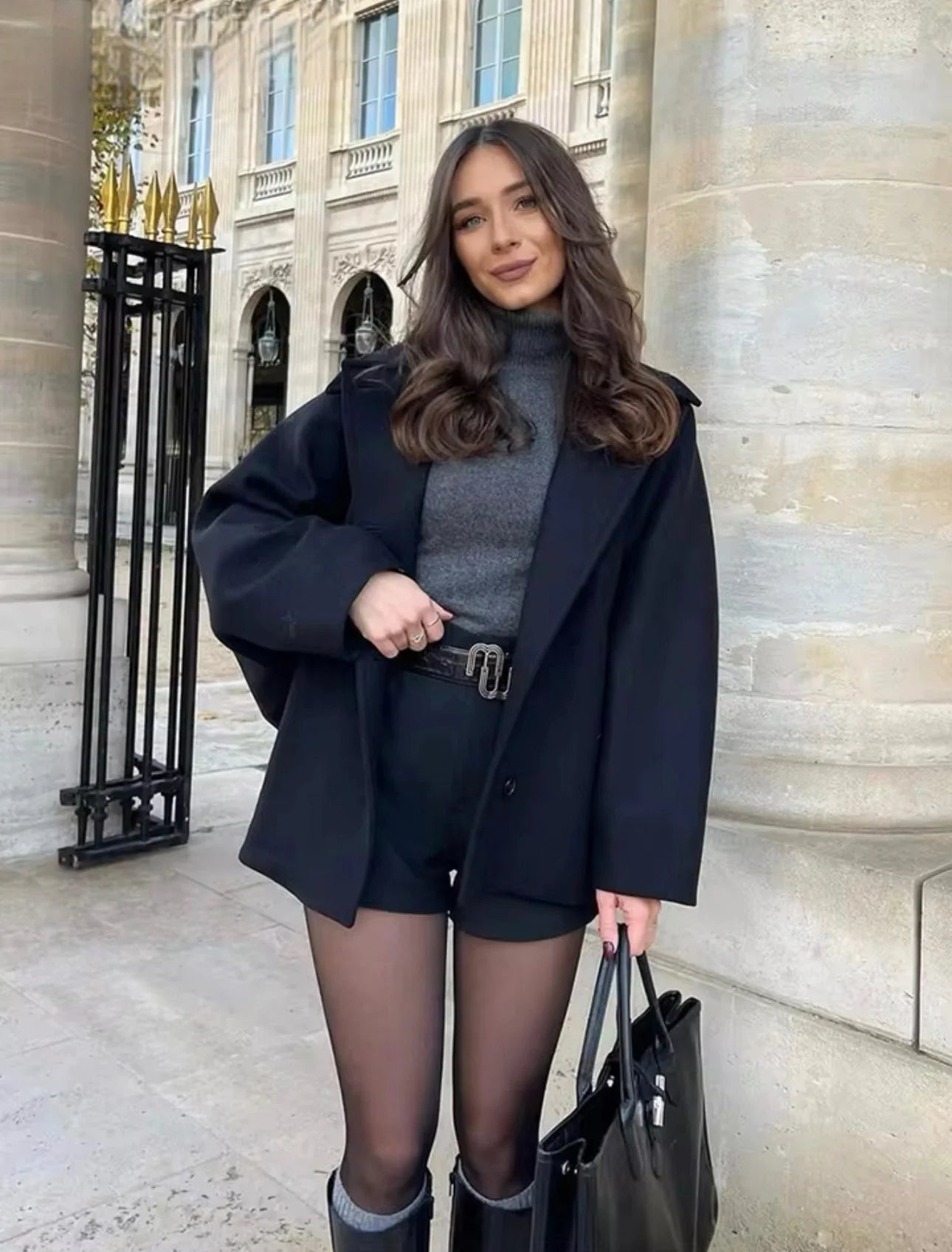 Women's oversized coat with wide lapels and button closure, made from soft wool blend for warmth and style.