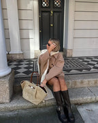 Women's oversized coat featuring wide lapels, button closure, and soft fabric for comfort and warmth in cooler weather.