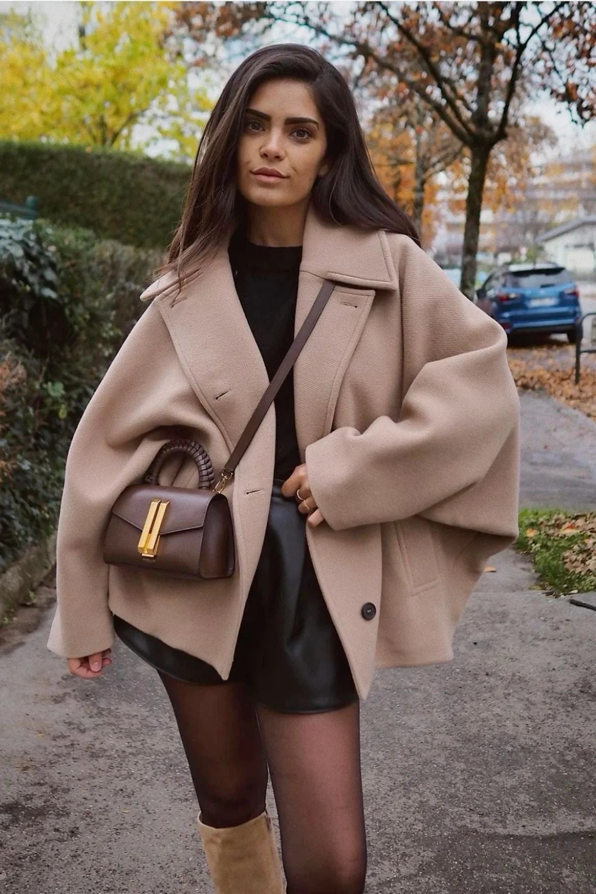 "Women's oversized coat featuring wide lapels, button closure, and soft wool blend fabric for warmth and style."