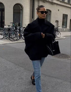 Women's oversized coat in soft fabric, featuring wide lapels, a button closure, and a relaxed silhouette for casual wear.