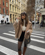 Women's oversized coat with wide lapels, button closure, made from soft wool blend for warmth and a relaxed fit.