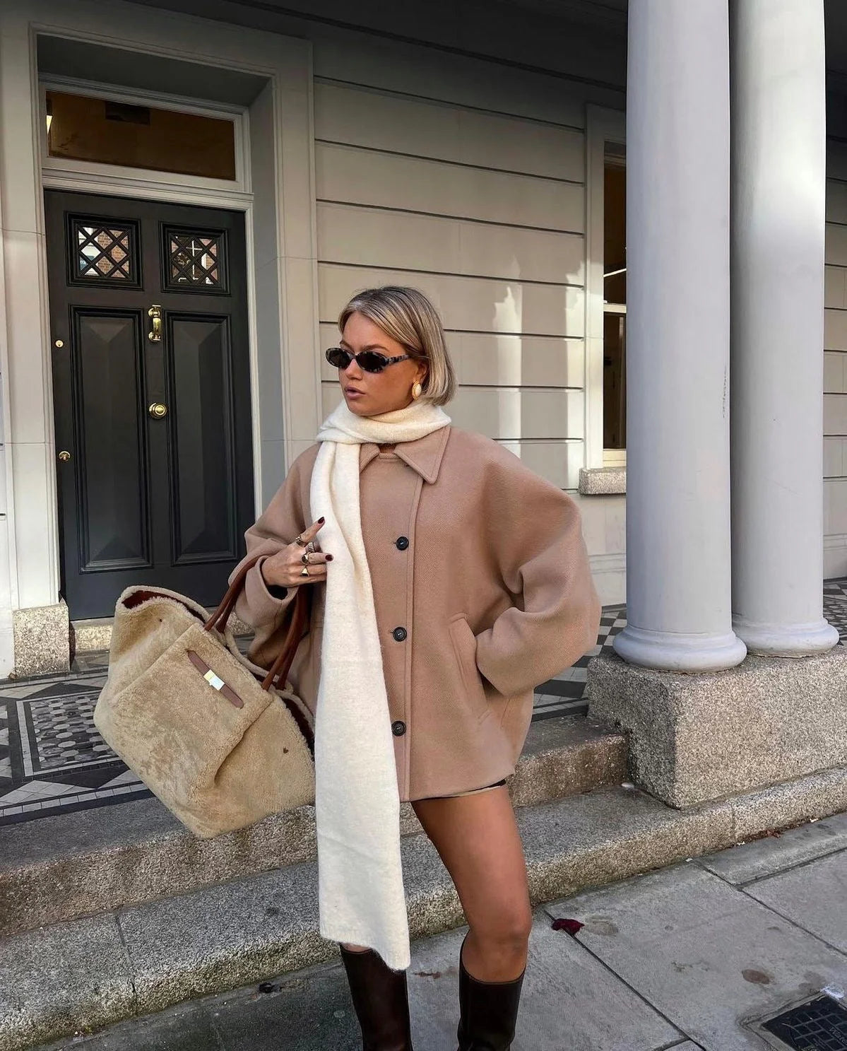 Women's oversized coat with wide lapels, button closure, crafted from soft wool blend for warmth and comfort.