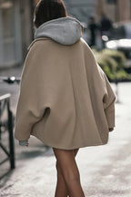Women's oversized coat in soft wool blend, featuring wide lapels and a single button closure for a stylish, relaxed fit.