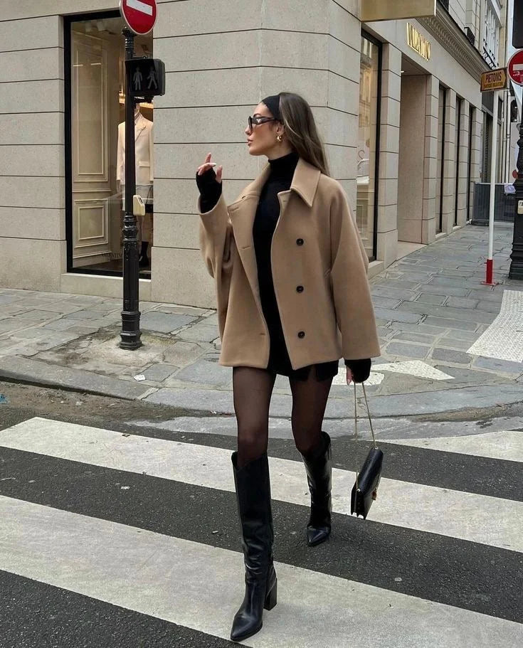 Women's oversized coat featuring wide lapels, button closure, and made from warm, durable fabric for comfort and versatility.